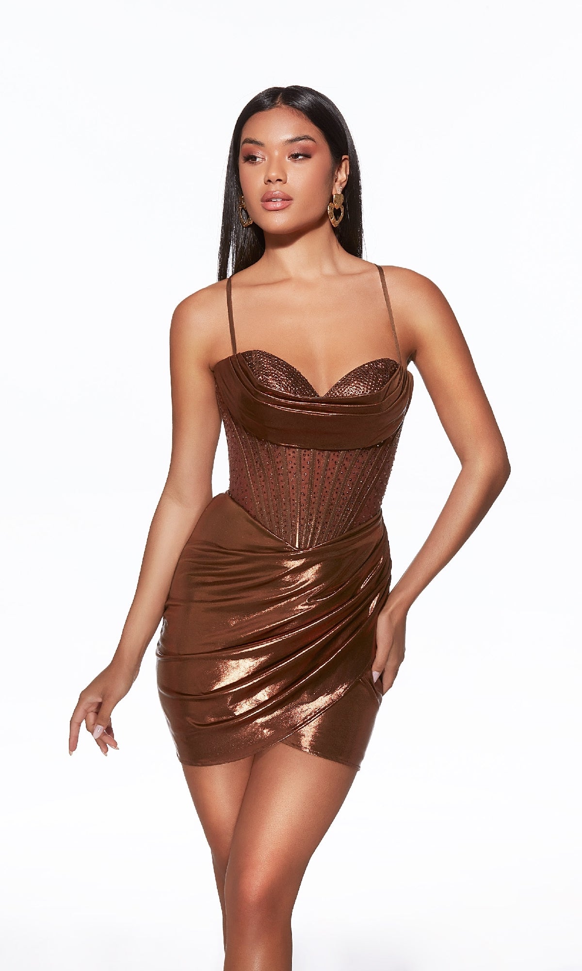 A woman models the Alyce 40103 short homecoming dress, featuring a metallic finish, corset bodice, thin straps, and draped skirt, against a plain white background.